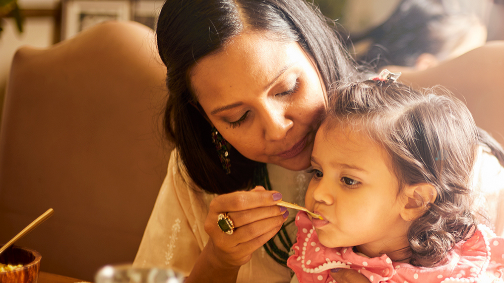 mom feeding her child